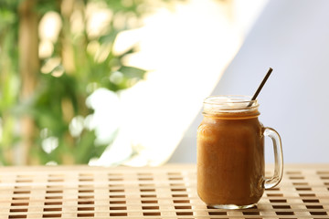 Wall Mural - Iced coffee in glass jar on wooden table