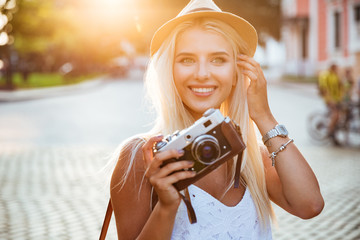 Poster - Close up portrait of a smiling girl holding retro camera