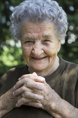 Portrait of happy elderly women sitting in garden. Old women