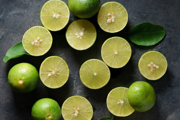 Wall Mural - fresh limes on dark background