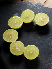 Wall Mural - fresh limes on dark background