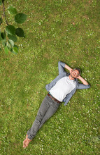 Top View. Handsome Grey Haired Man  Lying In The Grass