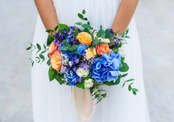 Bride holding blue wedding bouquet