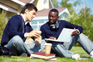 two young students sitting in campus