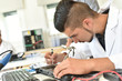 © goodluz - Student in technology fixing computer processing