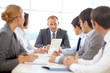 © pressmaster - Confident team of business people planning at a meeting