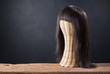genuine hair wig with weave mannequin on old wood and art dark background