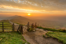 Golden Sunrise At Mam Tor In The English Peak District On A Hazy Autumn Morning With Wooden Gate.