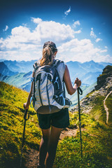 Wall Mural - Lone woman in shorts hikes through mountain pass