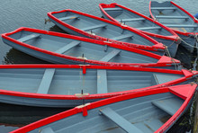 A Group Of Red And Grey Rowboats