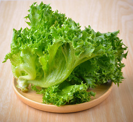 fresh lettuce on wooden plate