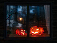 Halloween Pumpkin In The Mystical House Window At Night
