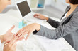 © pressmaster - Businesswoman working on computer and her left hand being manicured by beautician