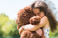 Girl Embracing Teddy Bear