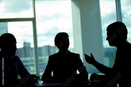 Fotografie, Obraz Three business people talking in dark office