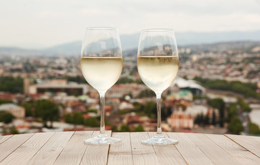 Two glasses on white wine on the table in Tbilisi, Georgia.