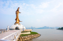 Statue Of Kun Iam Against Blue Sky In Macau. It Is Very Popular With Tourists And Foreigners