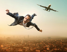 Business Man Flying From Passenger Plane Flying Over Sky Scraper