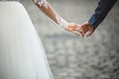 bride and groom hold each other's hands