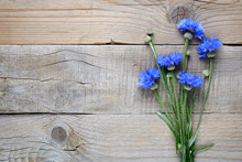 Blue Cornflowers On Wooden Background
