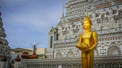 Buddha gold statue and thai art architecture in Wat Arun buddhist temple in Bangkok, Thailand. Selective focus.