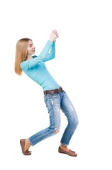 Wall Mural - back view of standing girl pulling a rope from the top or cling to something. girl  watching. Rear view people collection.  backside view of person.  Isolated over white background.