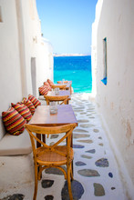Benches With Pillows In A Typical Greek Bar In Mykonos With Amazing Sea View On Cyclades Islands