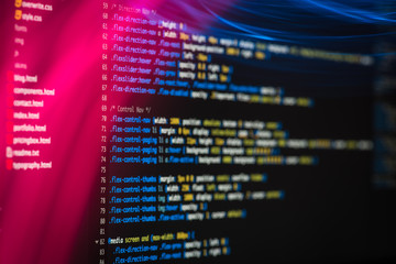 HTML and CSS code developing screenshot with light effects.