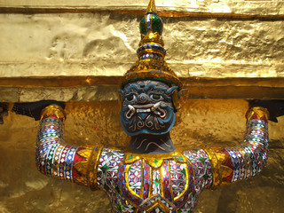 Guard on the base level of stupa in Wat Phra Keo, the great Royal Palace in Bangkok, Thailand.