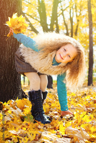 Fotografia, Obraz Beautiful Girl with Red Curly Hair in the Autumn Park - Sunny Day - Autumn Fall