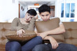 © Creativa Images - Young couple looks bored on the sofa