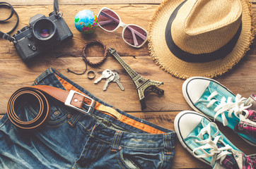 Clothing and accessories for travel on wood background