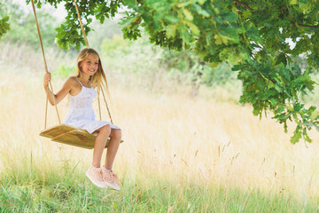 Cheerful kid playing on meadow