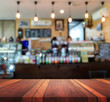 © sunshiro - Empty brown wooden table surface and Coffee shop interior blur background with bokeh image, for product display montage,can be used for montage or display your products.