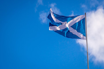 Flag of Scotland on the blue sky, with copy space for text