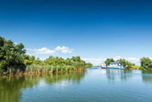 Typical Danube Delta Landscape With Lakes, Canals And Lush Vegetation On A Clear Sunny Day, In Gura Portitei Resort, Romania