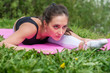 © undrey - Fit woman stretching, exercising on mat in nature.
