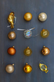Fototapeta Desenie - Christmas golden decorations on dark wooden background