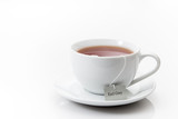 Fototapeta Perspektywa 3d - Earl Grey tea in a white cup on a saucer on a white background