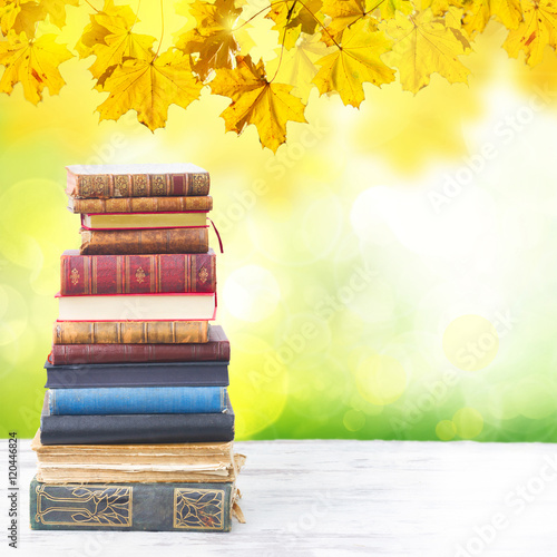 Tower Of Books On White Wooden Desktop With Fall Tree Leaves In Background Buy This Stock Photo And Explore Similar Images At Adobe Stock Adobe Stock