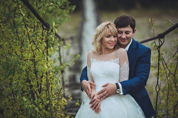 Nice couple has closed eyes, man holding  embracing her with clo