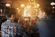 © Syda Productions - happy male friends drinking beer at bar or pub