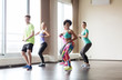 © Syda Productions - group of smiling people dancing in gym or studio