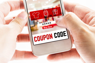 Poster - Close up Two hand holding mobile phone with coupon code word and