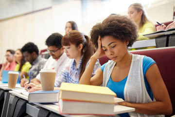 group of students with coffee writing on lecture