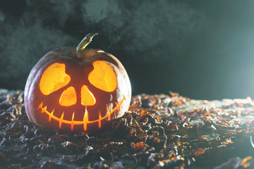 Poster - Halloween pumpkins at wood background. Carved scary faces of pumpkin.