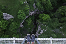 Man Feet Standing On The Edge Of Suspension Bridge In Khndzoresk