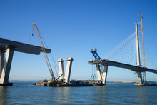The New Queensferry Crossing Bridge Under Construction, Seen From Port Edgar (Edinburgh, Scotland).  Showing A Mobile Crane Used For Lifting New Sections Of The Deck From Barges, And Bridge Piers.