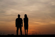 © weerajata - Silhouette man and woman with beautiful the sky at sunset..Backg