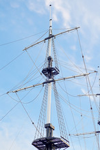 Masts Of Sailing Ship Against The Blue Sky.